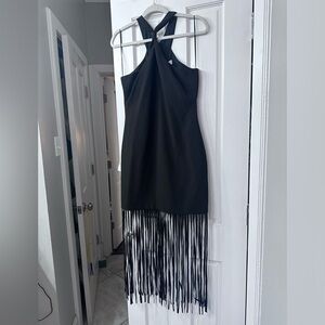 Likely halter style cocktail dress with fringe detail.